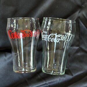 two 8oz coca cola drinking glasses.  Red printe and white print